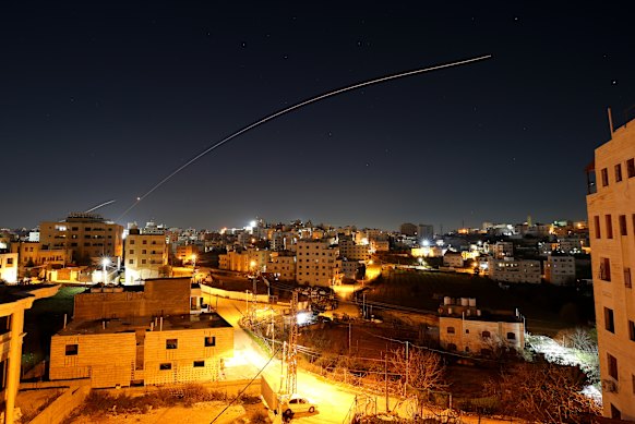 Iranian missiles streak over the sky in the West Bank in the early days of the war.