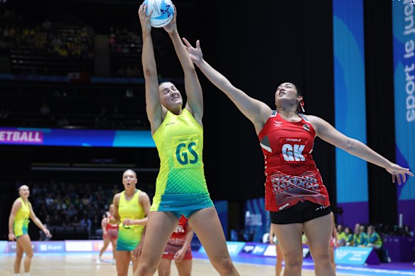 Sophie Garbin of Australia, left, and ’Otolose Fainga’anuku of Tonga in action during the the women’s netball.