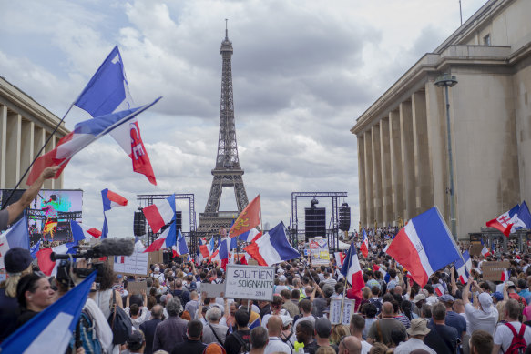 Thousands gather at Place Trocadero near the Eiffel Tower, Paris, to protest against the COVID-19 pass which grants vaccinated individuals greater ease of access to venues. 