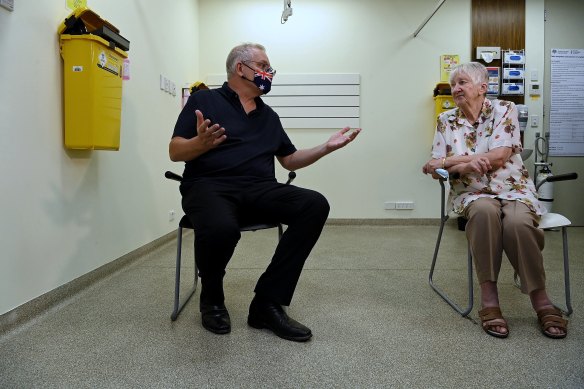 Morrison (left) talks with Jane Malysiak before receiving their COVID-19 booster vaccination at a medical centre in Blacktown. He says of the pandemic: “You focus on what you can control and you don’t think too much about the things you can’t in a crisis.”