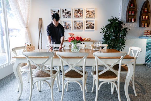 The Olala dining room is decorated in a beach house cottage-core style.