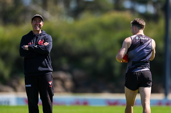 Brad Scott (left) and Merrett share a laugh at the star onballer’s first day back at pre-season training since his failed trade request.