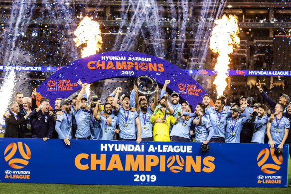 Reigning premiers Sydney FC will kick off the new A-League season in Adelaide, but there won't be much promotion until after the AFL and NRL finals series wrap up.