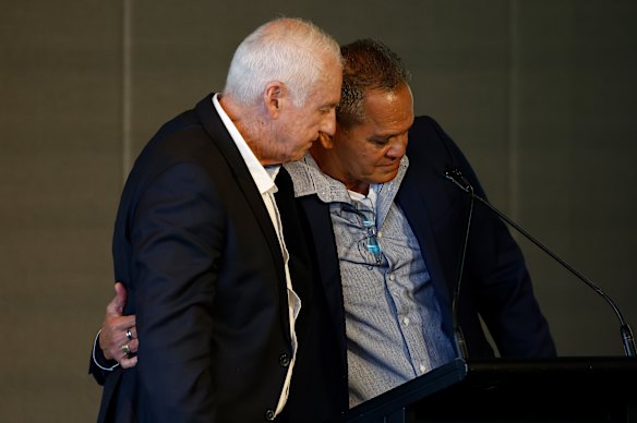 An emotional Scott Clayton (left) and Michael McLean embrace.