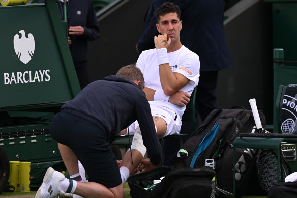 Thanasi Kokkinakis receives medical treatment.