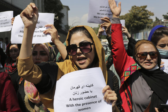 Women gather to demand their rights under the Taliban rule during a protest in Kabul on Friday