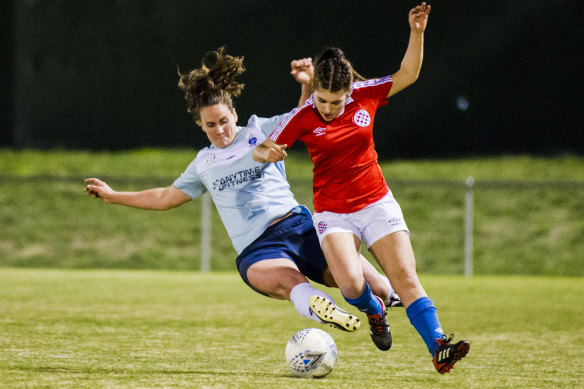 Belconnen's Karen Clarke tackles Canberra FC's goal-scorer Diarna Genovesi.