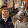 Prime Minister Narendra Modi greets supporters as he arrives at Bharatiya Janata Party headquarters in New Delhi on Tuesday.