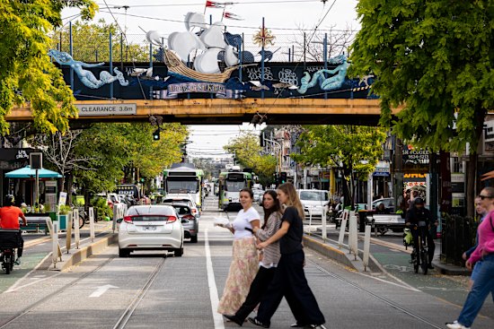 The train bridge north of Balaclava station as it crosses Carlisle Street, featuring the Lady of St Kilda art work.