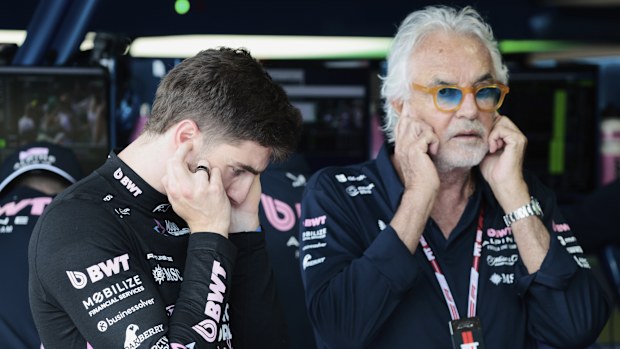 Alpine driver Jack Doohan of Australia and Flavio Briatore stand in the pit area before the qualifying session for the Formula One Miami Grand Prix auto race at the International Autodrome, Saturday, May 3, 2025, in Miami Gardens, Fla. (Shawn Thew/Pool Photo via AP)