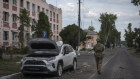 A Ukrainian soldier walks past city hall in Sudzha, Kursk region, Russia.
