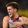 Zac Bailey of the Lions celebrates with Josh Dunkley after kicking a goal.