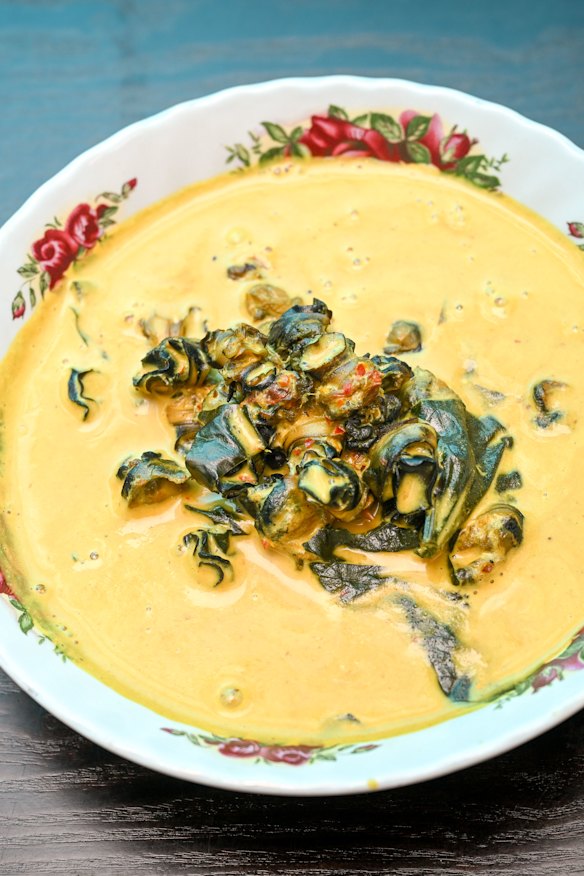 Yellow curry with betel leaves and black freshwater snails.