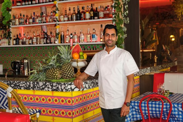 Chef Amar Singh at the bar decked out in clashing colours and patterns.