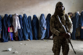 A Taliban fighter and women.