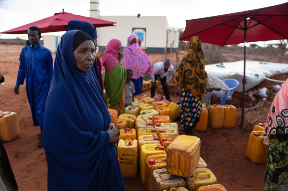 Women wait for water to be distributed at the village of Lumayo in Somaliland. Water must be trucked to many communities because of drought.