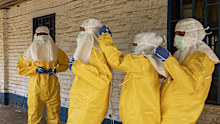 MONGBWALU, DEMOCRATIC REPUBLIC OF CONGO - MAY 26: << Members of the Médecins Sans Frontières (MSF) Ebola response team assist each other in securing protective suits and face shields outside the General Referral Hospital of Mongbwalu during outbreak preparedness and infection prevention activities>> on May 26, 2026 in Mongbwalu, Democratic Republic of Congo. The World Health Organization (WHO) and the Africa Centres for Disease Control and Prevention (Africa CDC) are deploying rapid response tea