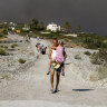 Tourists forced to flee as fire rages on Greek island