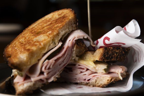 Toasted ham, cheese and pickle sandwich.