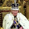 King Charles III and Queen Camilla smile during the King’s Speech in the House of Lord’s Chamber during the State Opening of Parliament on Wednesday.