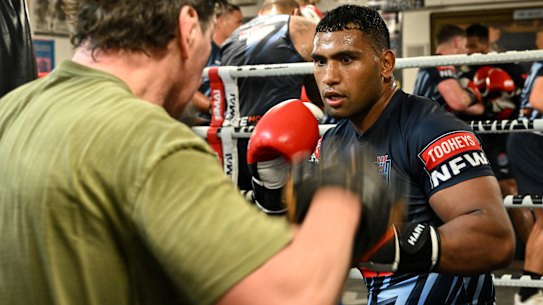 Tevita Pangai jnr spars with Mark Carroll in Origin camp on Tuesday.