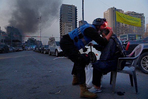 Kate Geraghty’s powerful photograph of a Lebanese emergency first responder kissing the head of an elderly man moments after a building in the Bachoura district in central Beirut was hit by one of three Israeli airstrikes on March 12.