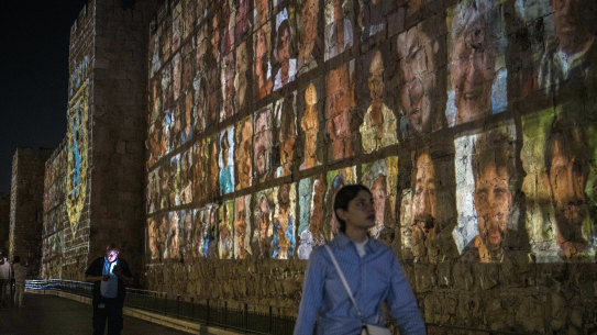 Images of those taken hostage by Hamas militants are projected on the outer wall of the Old City of Jerusalem.