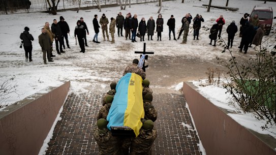 Ukrainian soldiers carry the coffin of their fallen comrade in Bucha in January.