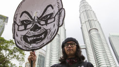 Fahmi Reza holds a cartoon character of then Malaysian Prime Minister Najib Razak in 2016. 