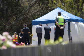Officers inspect the jumping castle at Hillcrest Primary School after the tragic incident on Thursday.