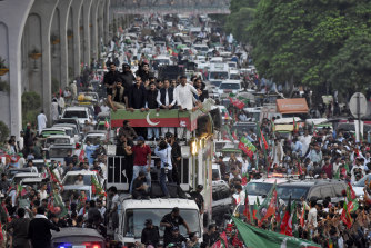 Pakistani opposition leader Imran Khan, second right on the truck, leads a rally against recent price hikes in Rawalpindi, Pakistan.