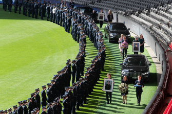 The guard of honour for the dead officers stretched around the boundary at Marvel Stadium