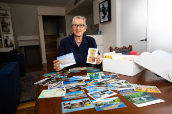 A member of the Manly branch Diana Whitton with some of the 150 postcards sent by branches to mark the organisation’s 100th birthday. 