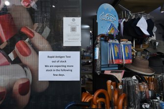 A sign in the window of a pharmacy at Circular Quay alerting customers that it has run out of stock of rapid antigen test kits.