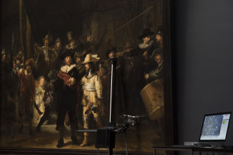 A microscopic image enlarging a 4x6 millimetre part of The Night Watch is seen on a screen next to the painting at the Rijksmuseum. 