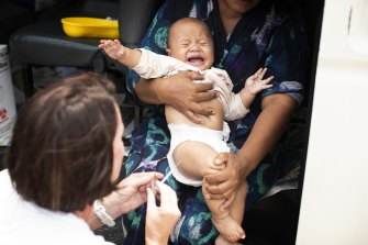 A child is vaccinated against measles at a Red Cross centre in Apia, Samoa. 