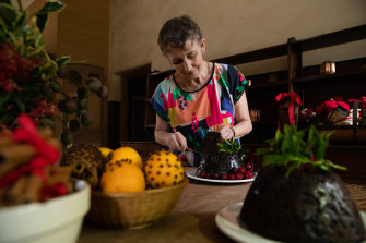 Jacqui Newling, resident gastronomer at Vaucluse House, with the two plum puddings she has made, one with suet and the other with butter.