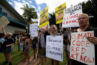 Protesters at the Lismore Council Chambers wait for the Prime Minister to arrive on Wednesday.
