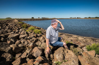 Developer Dennis More sitting at the shore of Corio Bay on the property he owns. 