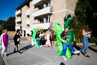Trick or treaters stream down the street in North Bondi.