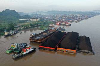 Tugboats and barges transporting coal are moored on the Mahakam River in Samarinda, East Kalimantan, Indonesia. 