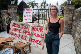 Protester Kate Stroud dumped her flood-ruined belongings on the Prime Minister’s door this morning.