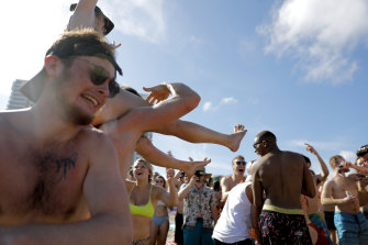 Spring break revellers party together, ignoring restrictions, in Florida last month.