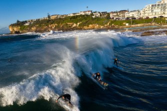 Surfers make the most of the big swell at Dee Why on Monday morning.