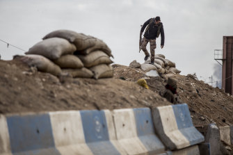 A fighter with the Kurdish-led Syrian Democratic Forces mans a checkpoint in Hasaka, Syria,