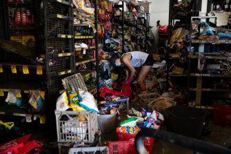 Friends, family and community volunteers all help to clean up the damaged shops in Woodburn.