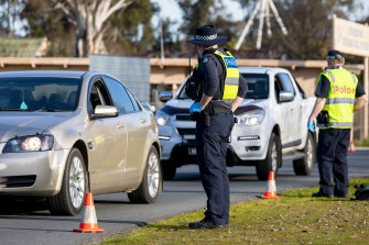 Victoria has shut the border to all of NSW and the ACT. Police stop cars entering a checkpoint between Albury and Wodonga on Sunday. 