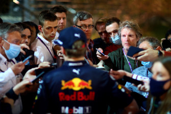 Dutch driver Max Verstappen (back to camera) talks to the media after the Bahrain F1 Grand Prix.