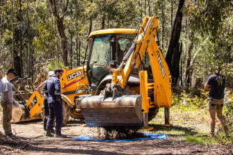 Earthmoving equipment arrives to help in the search for Russell Hill and Carol Clay.