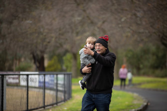 Playground designer John Arena with one-year-old grandson Isaiah at Croydon Park.